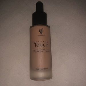 Partial bottle of ORGANZA Liquid Touch Foundation